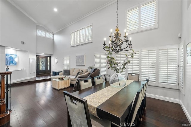 dining area featuring an inviting chandelier, crown molding, and plenty of natural light