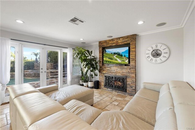 living room featuring ornamental molding, french doors, and a fireplace