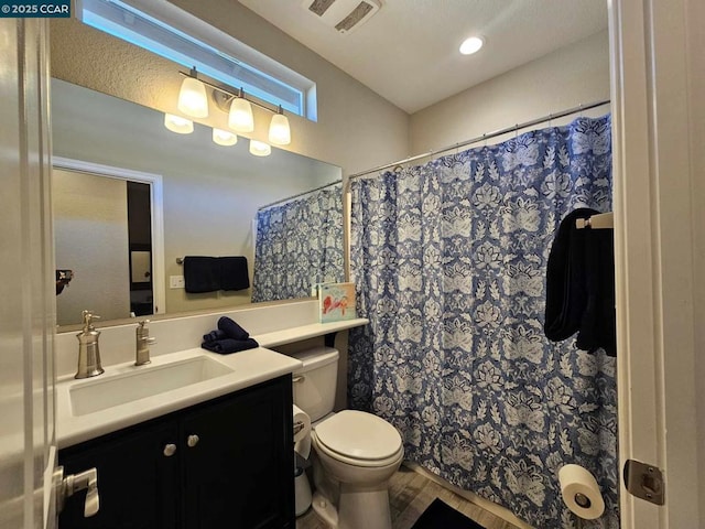 bathroom with toilet, wood-type flooring, and vanity