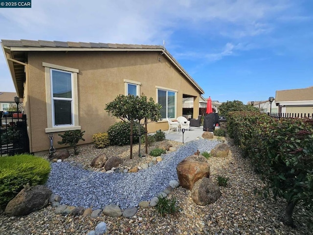 view of side of property with a patio area