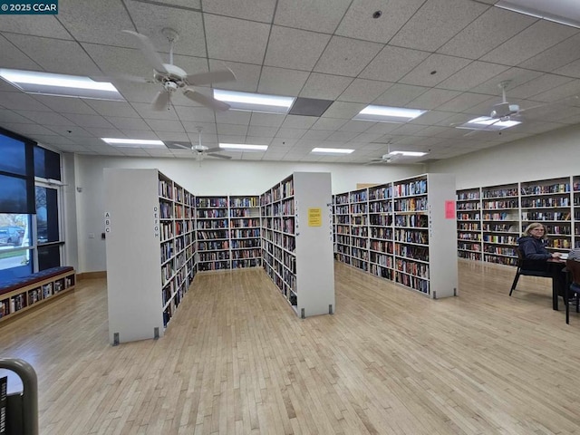 interior space featuring light wood-type flooring and a paneled ceiling