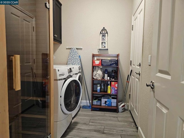 laundry room featuring cabinets and separate washer and dryer