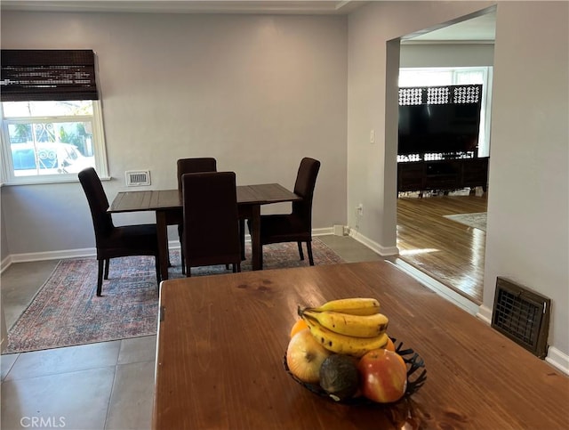 dining area with dark tile patterned floors