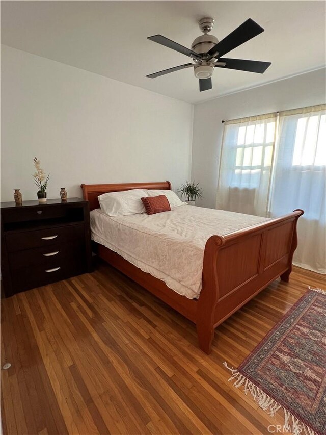 bedroom featuring ceiling fan and dark wood-type flooring