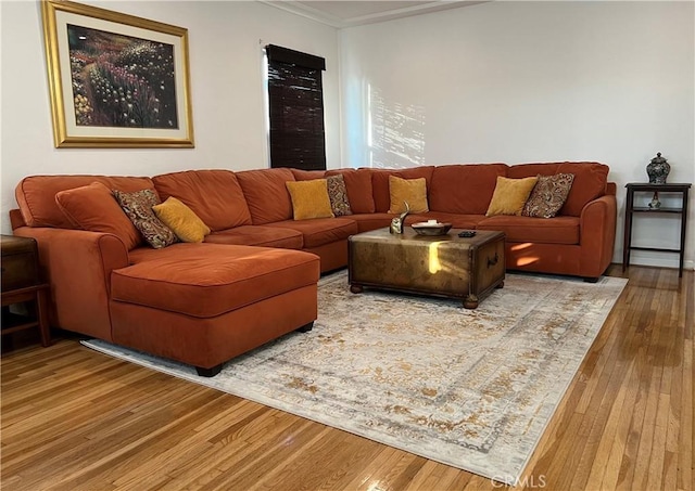 living room with hardwood / wood-style flooring and crown molding