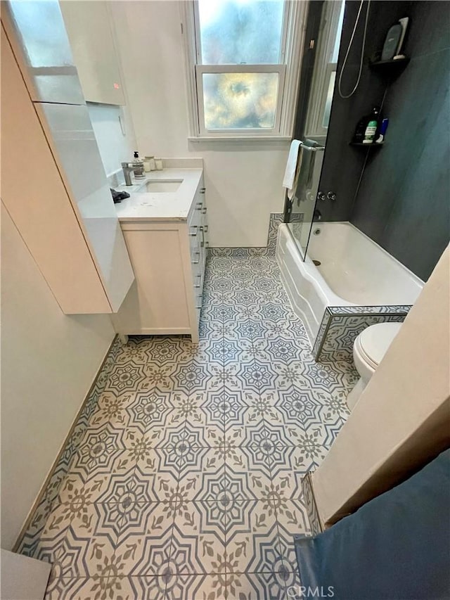 full bathroom featuring tile patterned flooring, vanity, washtub / shower combination, and toilet