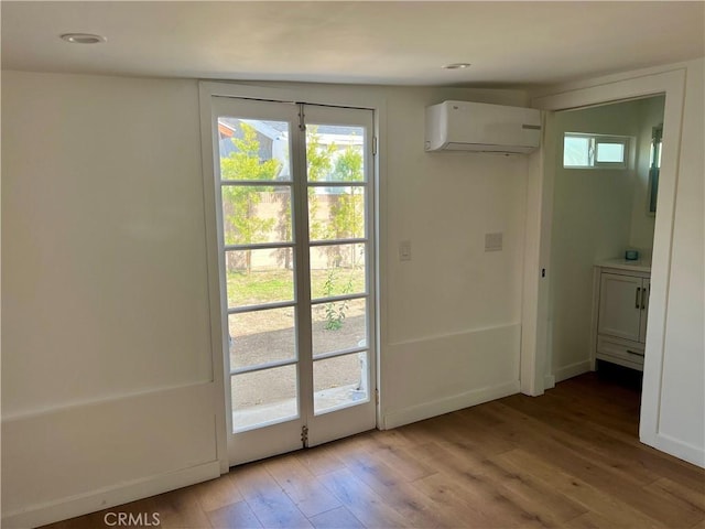 2647 Kansas Ave, South Gate, CA 90280 - doorway with an AC wall unit, light wood-type flooring, healthy amount of natural light, and recessed lighting