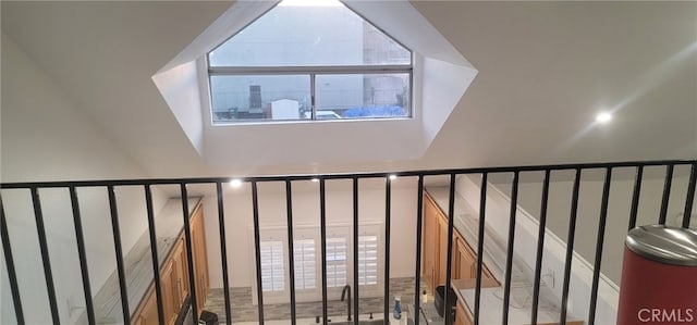 staircase with lofted ceiling and a healthy amount of sunlight