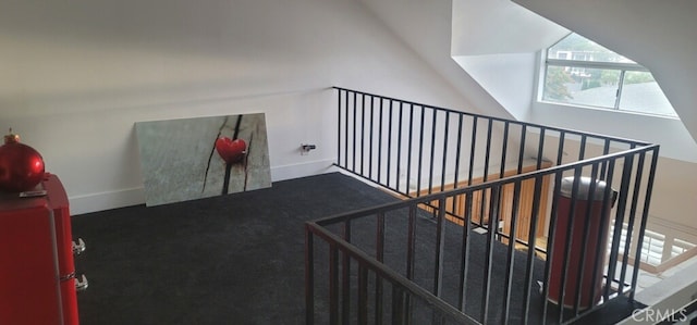 stairway with vaulted ceiling and carpet floors