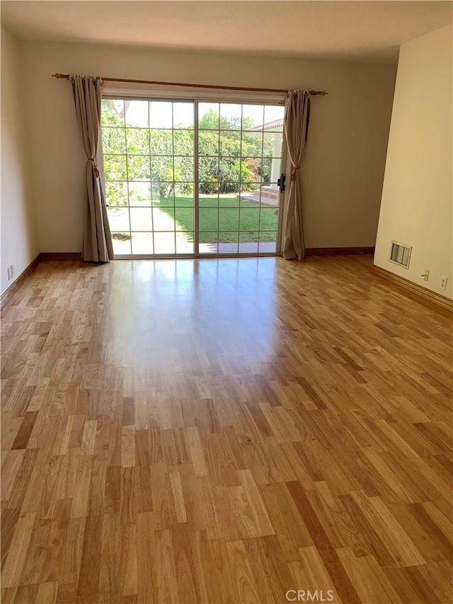 empty room with light wood-type flooring