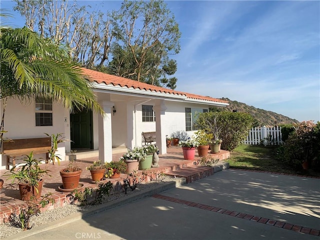 back of house featuring a patio area and a mountain view