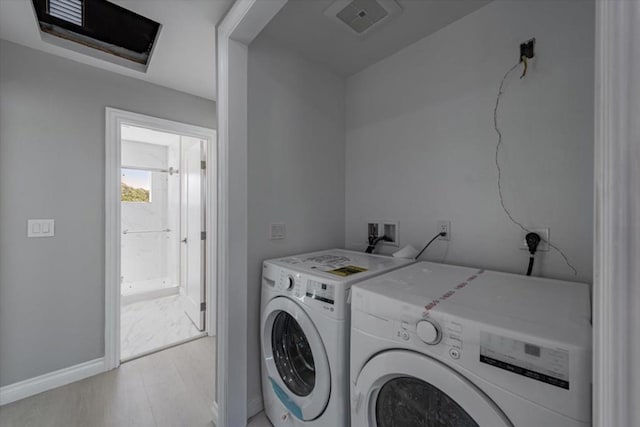 clothes washing area featuring washing machine and clothes dryer