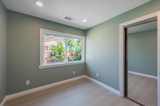 unfurnished bedroom with light hardwood / wood-style floors and a closet