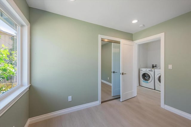 washroom featuring light wood-type flooring and washing machine and clothes dryer