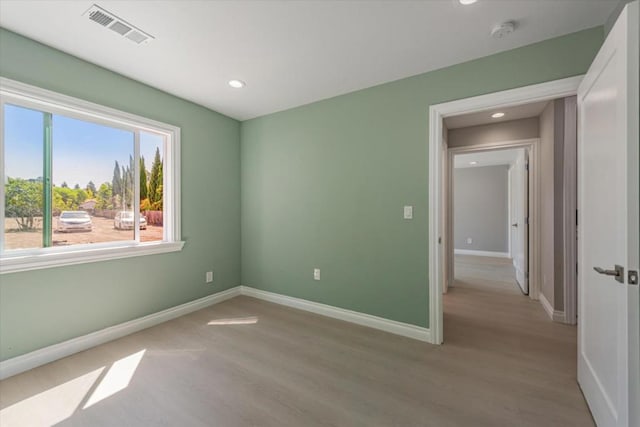 unfurnished room with light hardwood / wood-style floors