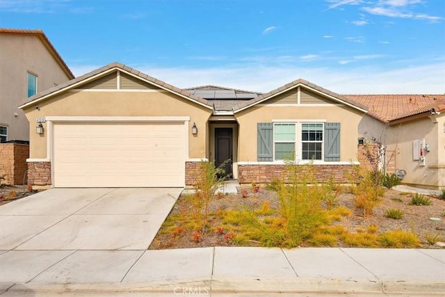 view of front of home with solar panels and a garage