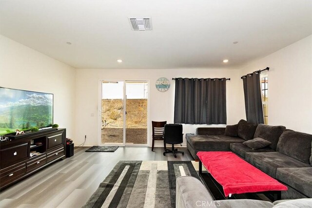 living room with a healthy amount of sunlight and light hardwood / wood-style flooring