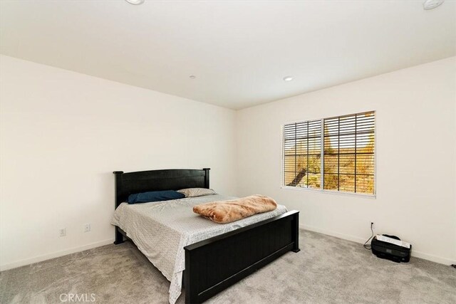 bedroom featuring light carpet