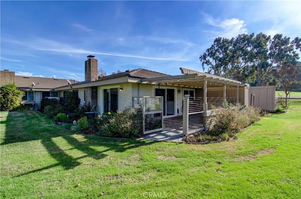 rear view of property with a yard