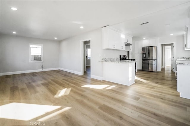 kitchen with white cabinetry, stainless steel fridge with ice dispenser, light stone countertops, and light wood-type flooring