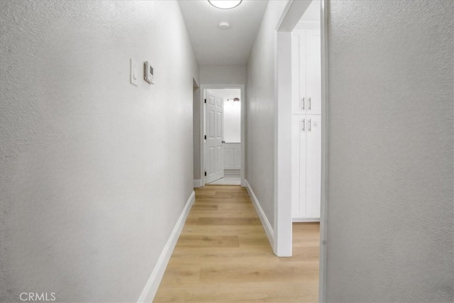 hall with light hardwood / wood-style flooring