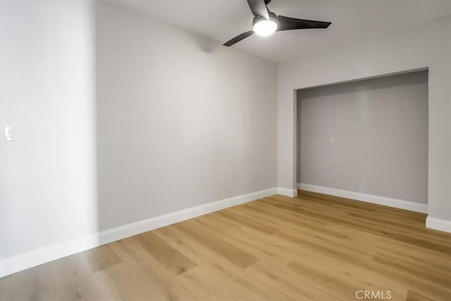 spare room with wood-type flooring and ceiling fan