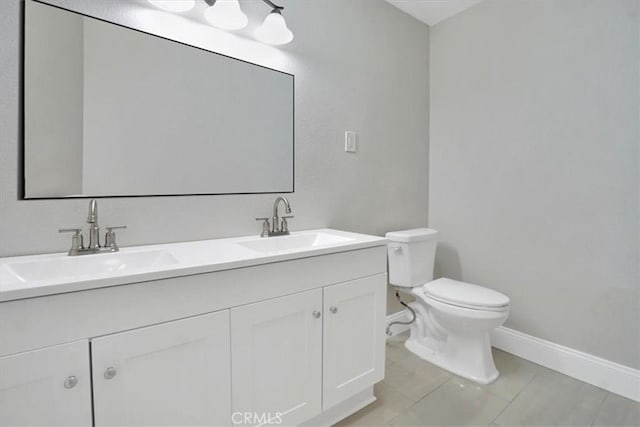 bathroom with tile patterned floors, vanity, and toilet