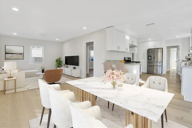 dining room featuring light hardwood / wood-style flooring and cooling unit