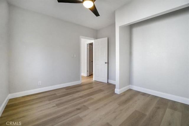 unfurnished bedroom featuring ceiling fan and light wood-type flooring