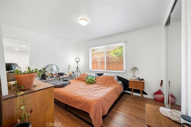 bedroom with dark hardwood / wood-style flooring