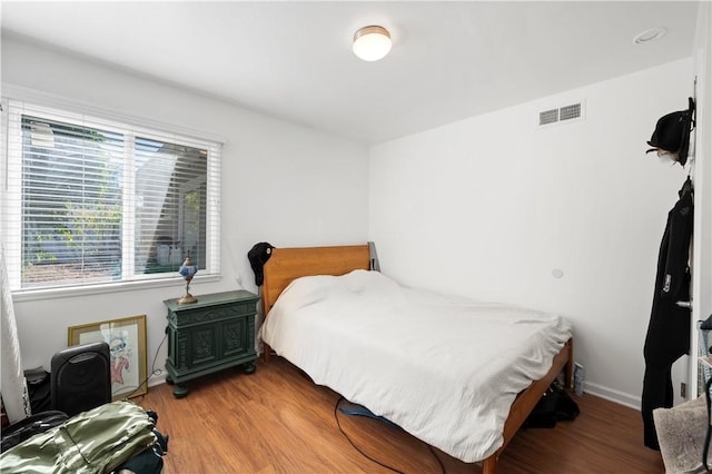 bedroom with hardwood / wood-style flooring