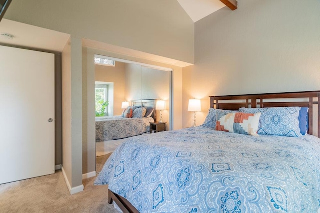 carpeted bedroom with lofted ceiling