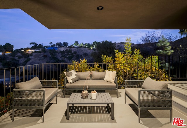 view of patio featuring an outdoor living space and a mountain view