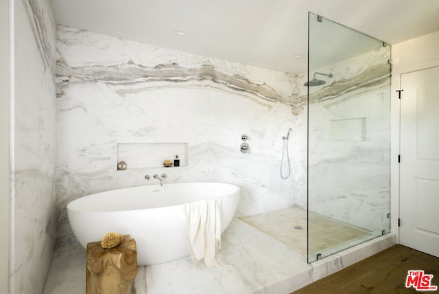 bathroom featuring hardwood / wood-style flooring and plus walk in shower