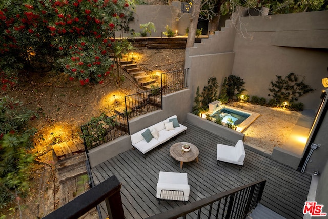 exterior space featuring a jacuzzi and an outdoor hangout area