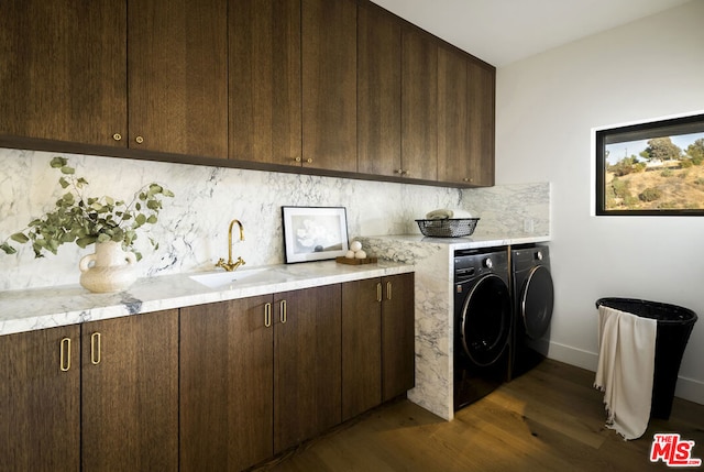 laundry room with cabinets, sink, independent washer and dryer, and dark wood-type flooring