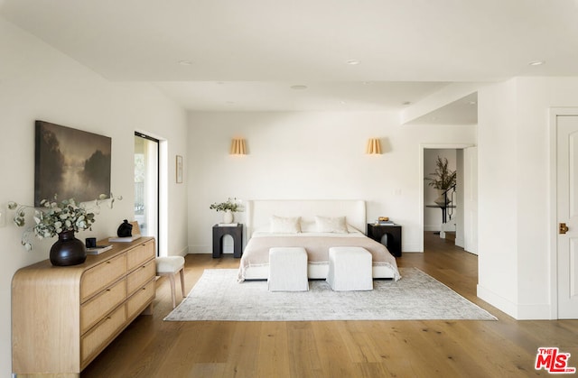 bedroom with hardwood / wood-style floors