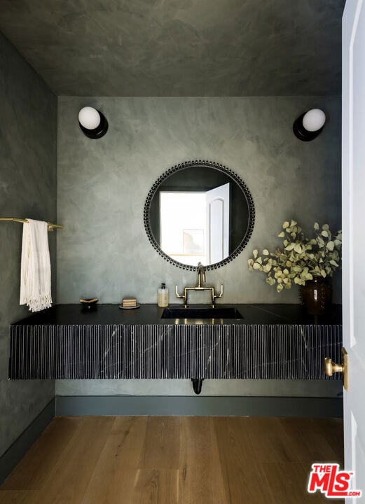 bathroom with sink and hardwood / wood-style flooring