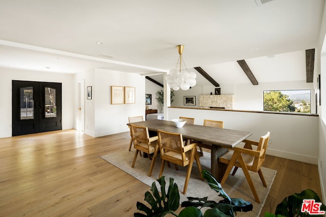 dining space with french doors, light hardwood / wood-style floors, vaulted ceiling with beams, and a notable chandelier