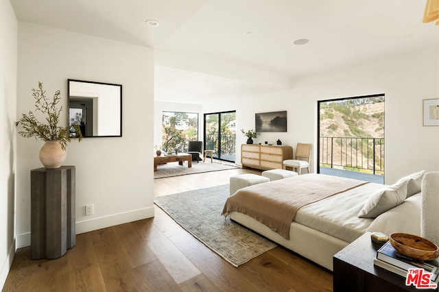 bedroom featuring hardwood / wood-style floors and access to outside