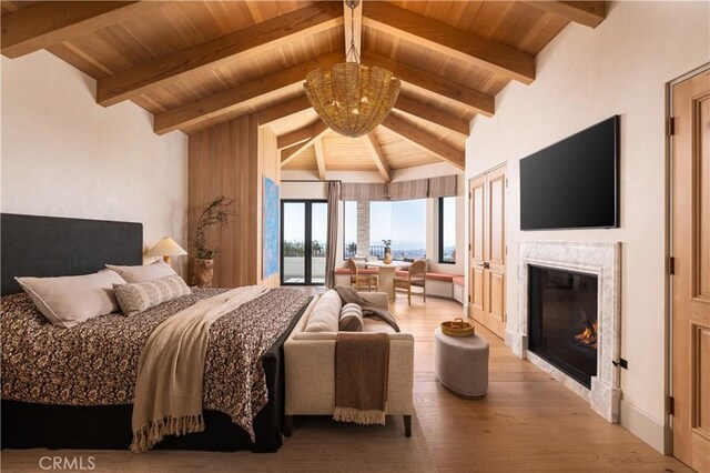 bedroom featuring a notable chandelier, lofted ceiling with beams, and wood-type flooring