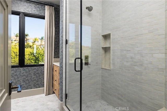 bathroom featuring an enclosed shower and vanity