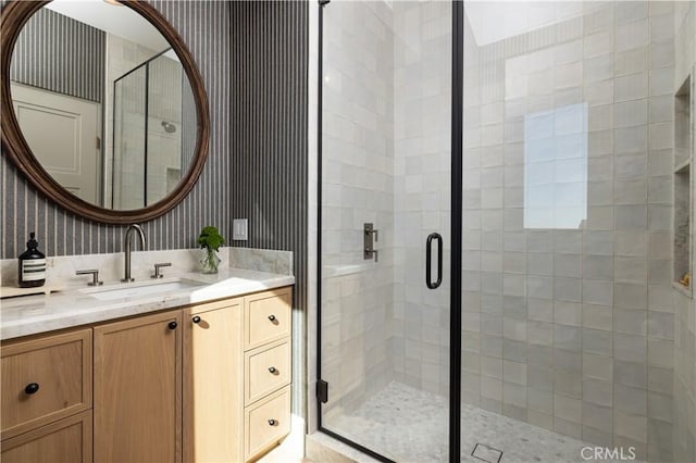 bathroom with an enclosed shower and vanity