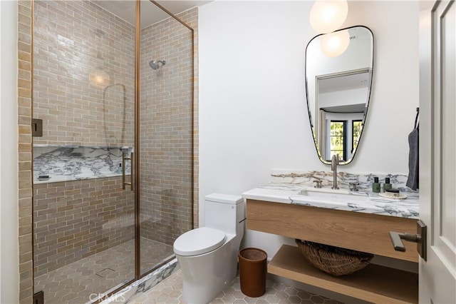 bathroom with walk in shower, vanity, tile patterned floors, and toilet