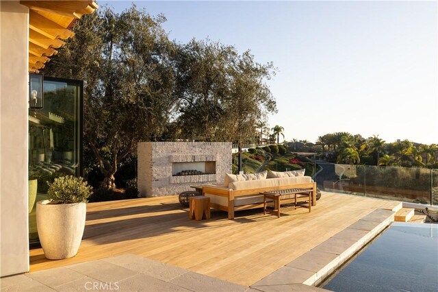 view of patio featuring an outdoor living space with a fireplace