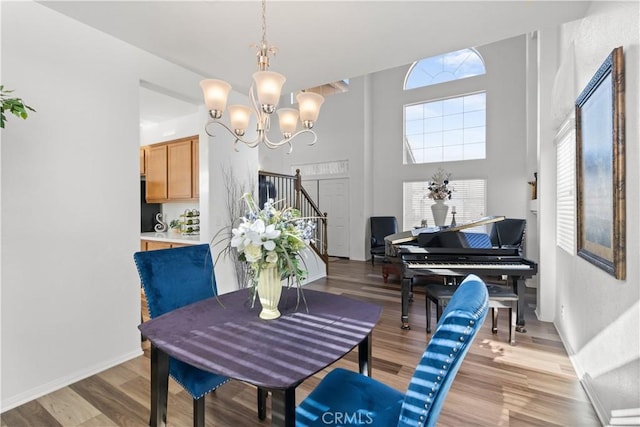 dining space with light wood-type flooring and a chandelier