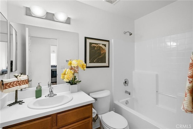 full bathroom with toilet, vanity, and  shower combination