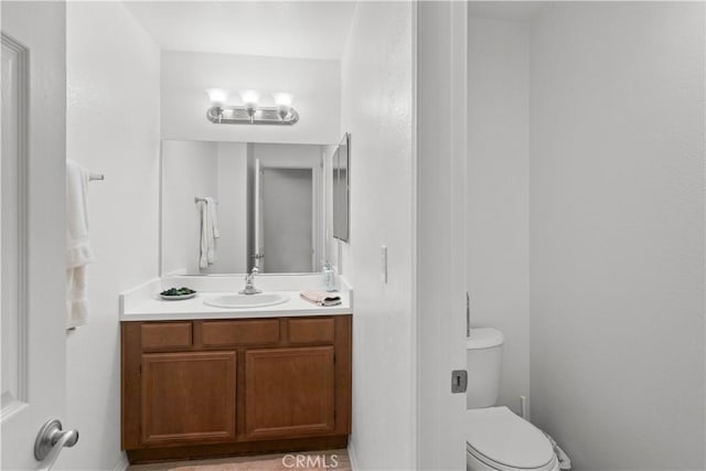 bathroom with toilet and vanity