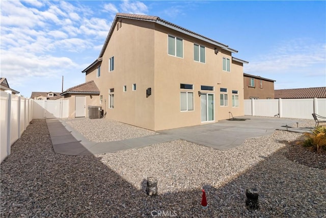 back of property featuring central AC unit and a patio