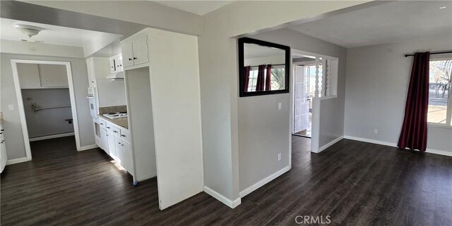 kitchen featuring white cabinets, extractor fan, dark hardwood / wood-style floors, and plenty of natural light